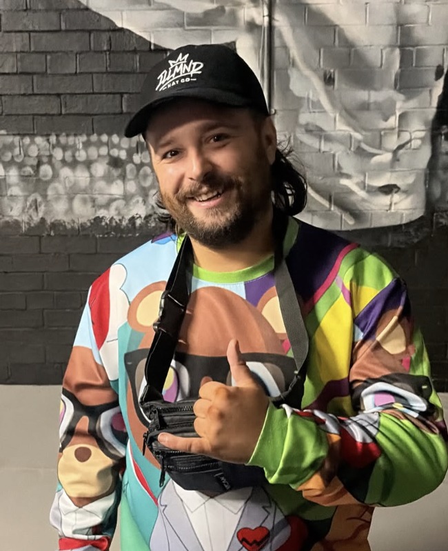 Black Genesis cap worn with a graphic sweatshirt
