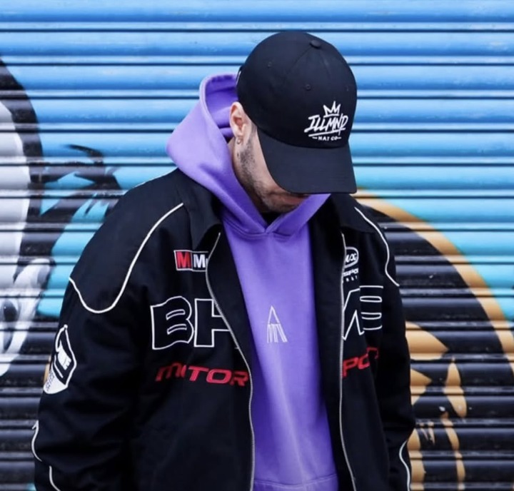 Black Genesis cap worn with a motorsport jacket